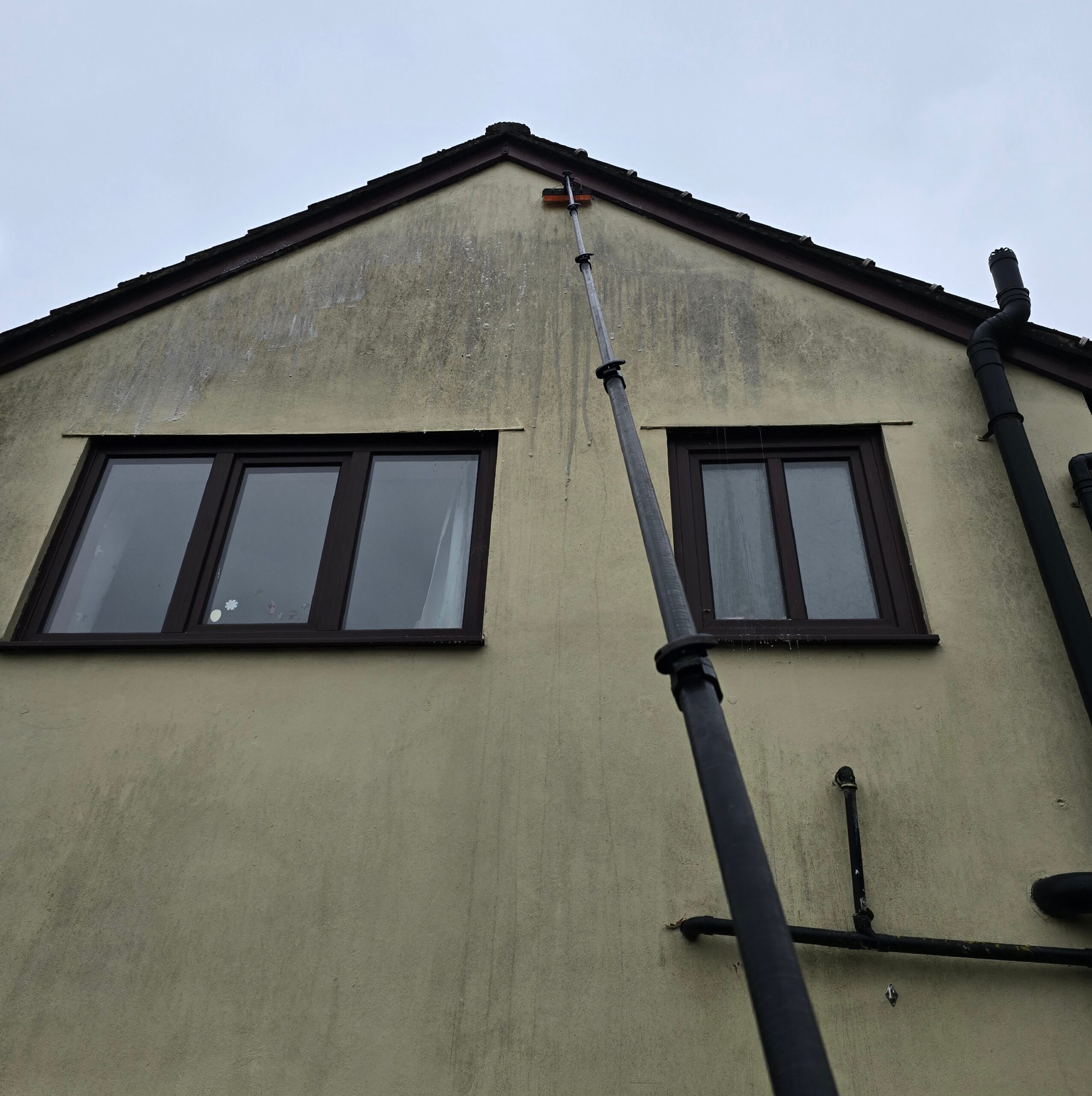 Rendered house before soft washing in Newport